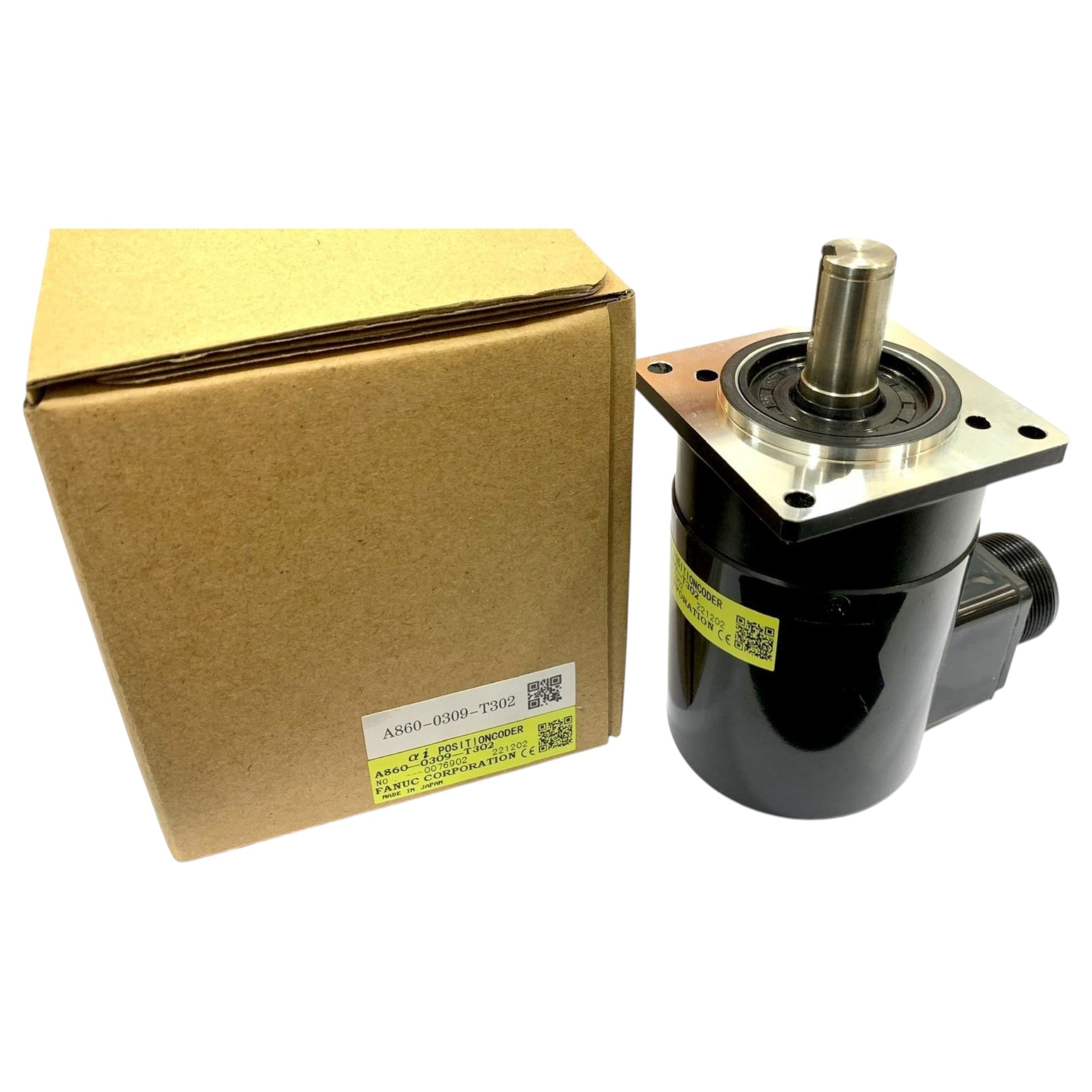 JJAutomation FANUC A860-0309-T302 CNC encoder with metal shaft and black housing next to its original cardboard box.