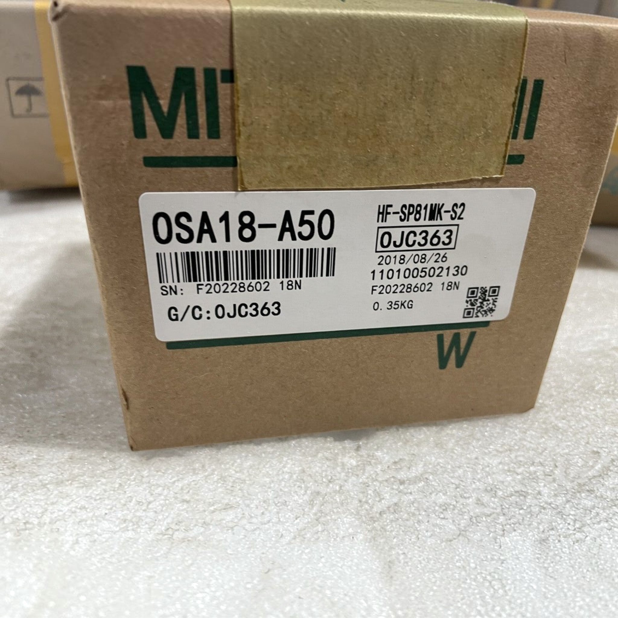 JJAutomation Mitsubishi Electric OSA18-A50 servo motor encoder label on cardboard packaging for industrial machinery